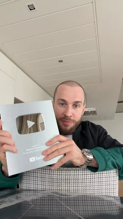Silver play-button plaque in a casual update