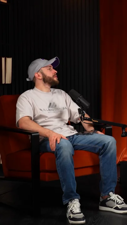 Gray cap and tee against red upholstery